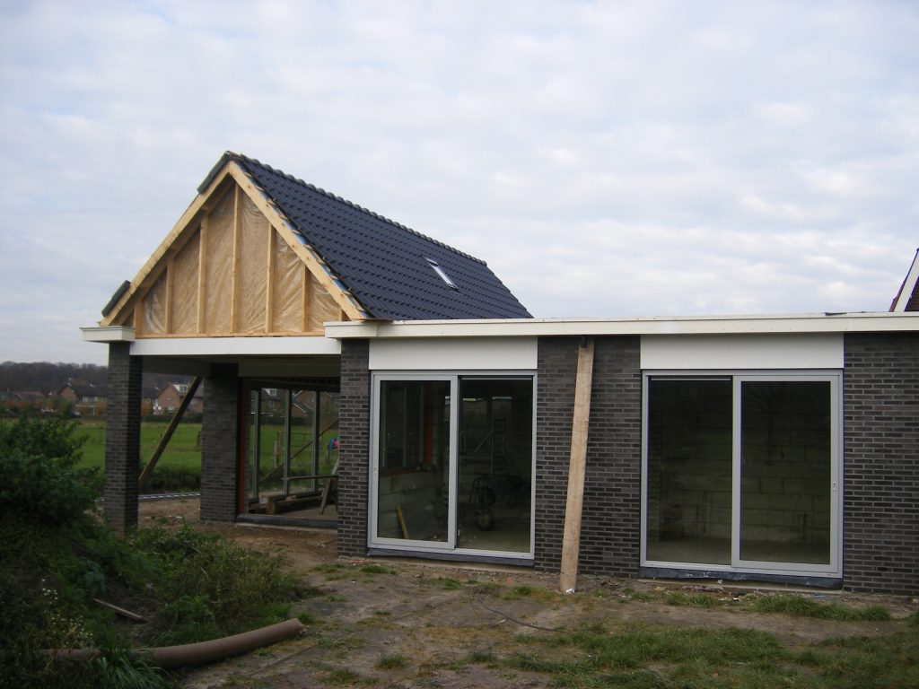 Aanbouw met grote glazen schuifpuien tijdens de bouw